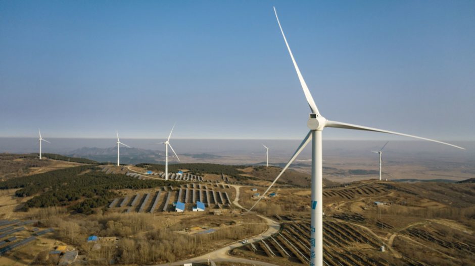 Wind turbines and solar panels on a hillside in China. Photographer: Qilai Shen/Bloomberg