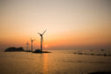 Daebu Island, Ansan-si, Gyeonggi-do, Korea - March 8, 2020: Sunset view of the sea with tourists and wind power plants