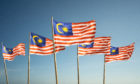 Malaysian flags flutter in the wind.