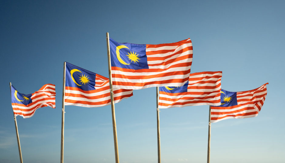 Malaysian flags flutter in the wind.