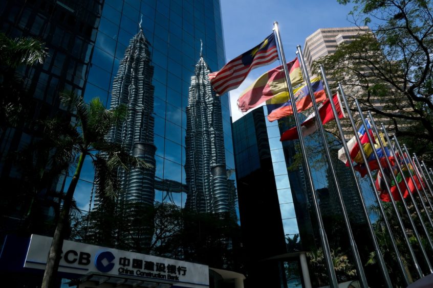 The Petronas Twin Towers stand reflected in the windows of the China Construction Bank Corp. office in Kuala Lumpur, Malaysia, on Wednesday, Jan. 30, 2019. Photographer: Samsul Said/Bloomberg