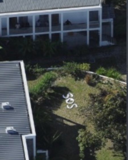 SOS spelled out in garden