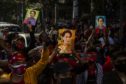 Demonstrators hold up images of Aung San Suu Kyi during a protest against Myanmar coup outside the Embassy of Myanmar in Bangkok, Thailand, on Monday, Feb. 1, 2021. Photographer: Andre Malerba/Bloomberg