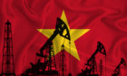 Silhouette of drilling rigs and oil derricks on the background of the flag of Vietnam.