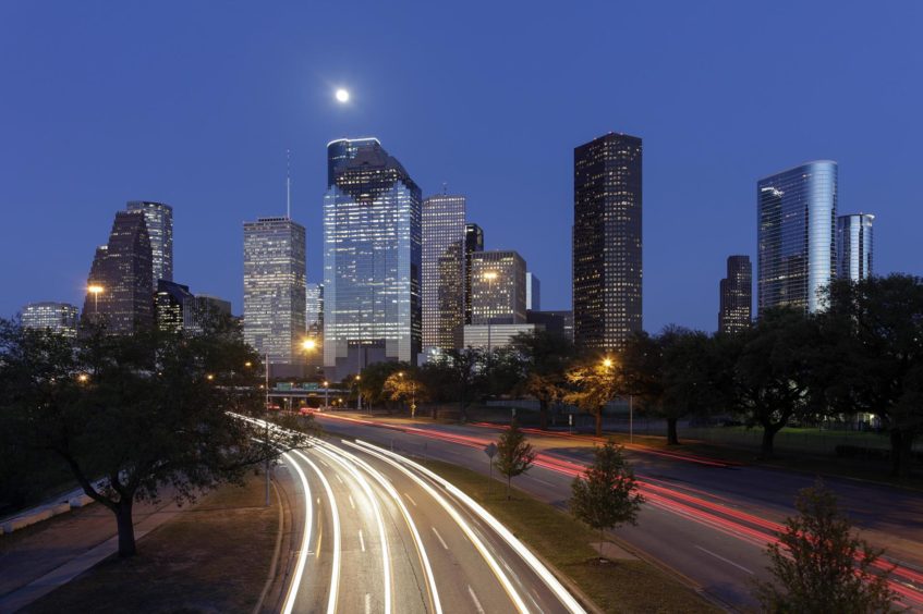 Night time with car light trails and skyscrapers