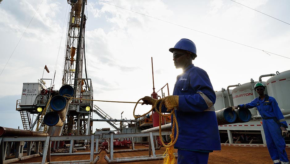 Worker in blue overall amid equipment