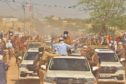 President Deby in a car driving through dusty road in Mao, Chad