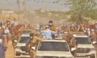 President Deby in a car driving through dusty road in Mao, Chad