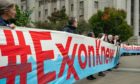A protest on the first day of the ExxonMobil trial in the New York State Supreme Court building.