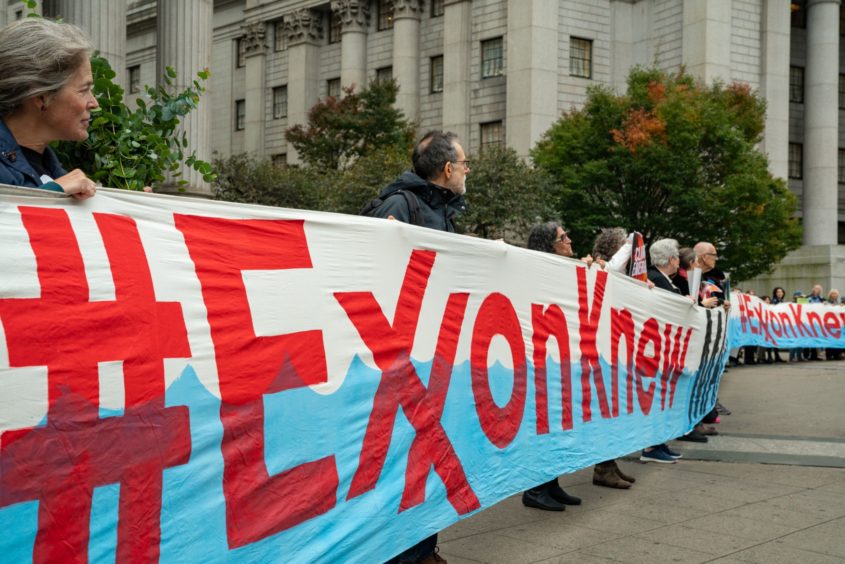 A protest on the first day of the ExxonMobil trial in the New York State Supreme Court building.
