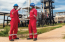 Two workers in Tanzania's Mnazi Bay dressed in red overalls