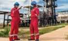 Two workers in Tanzania's Mnazi Bay dressed in red overalls