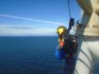 A PD&MS rope access technician working at a wind farm