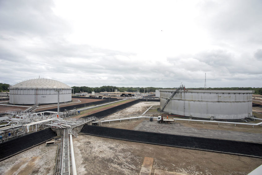 Oil tanks under a cloudy sky