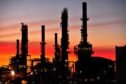 The Caltex Australia Ltd. Lytton refinery is silhouetted against a sunset in Brisbane, Australia, on Tuesday, Dec. 21, 2010.