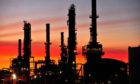 The Caltex Australia Ltd. Lytton refinery is silhouetted against a sunset in Brisbane, Australia, on Tuesday, Dec. 21, 2010.