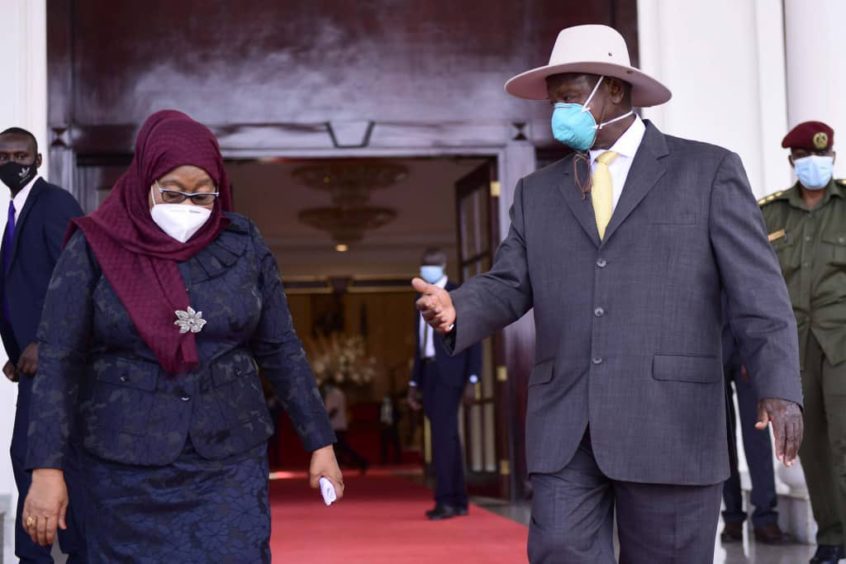 President Hassan in a headscarf on the left with President Museveni on the right in a mask