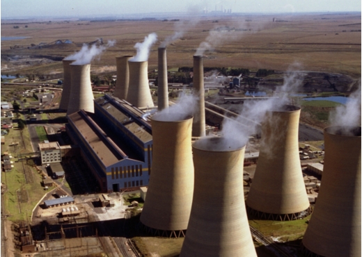 Chimneys billow smoke at the Komati power plant