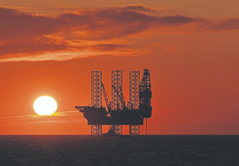 Oil rig with the sun setting in the North Sea.