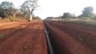 Red earth with a pipeline in a trench
