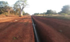 Red earth with a pipeline in a trench