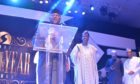 Executive behind lectern on stage receives award