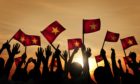 A group of people waving Vietnamese flags.