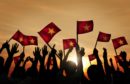 People waving Vietnam flags.