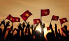 People waving Vietnam flags.