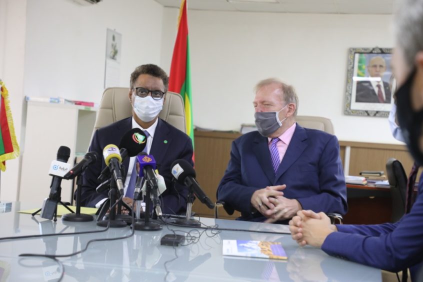 Mauritania and CWP officials sit at a table, with microphones