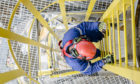 Top down shot of a man climbing down a ladder.