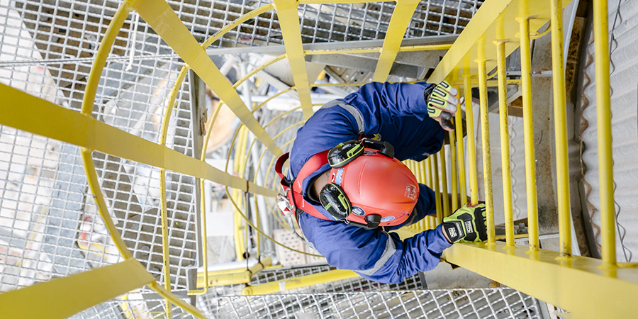 Top down shot of a man climbing down a ladder.