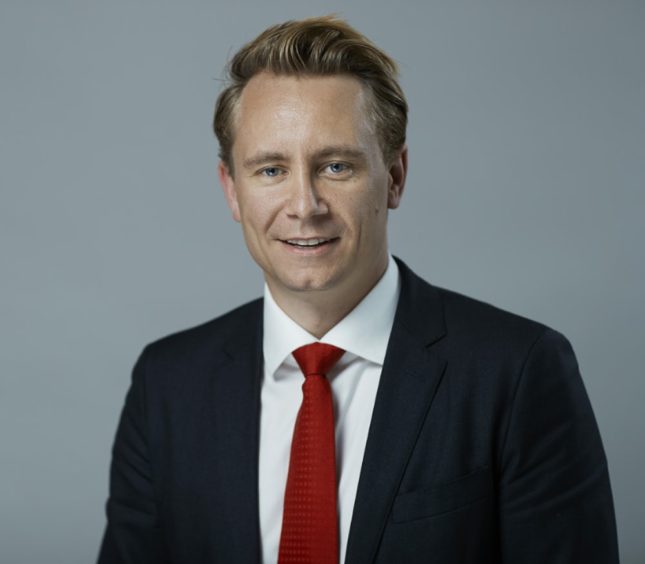 Man in grey suit with red tie 