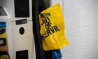 An empty pump at a gas station is covered with a yellow plastic bag following a cyber attack on the Colonial Pipeline.
