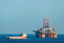 Supply vessel Normand Aurora next to West Phoenix oil rig in the North Sea. Olaf Kruger/imageBROKER/Shutterstock