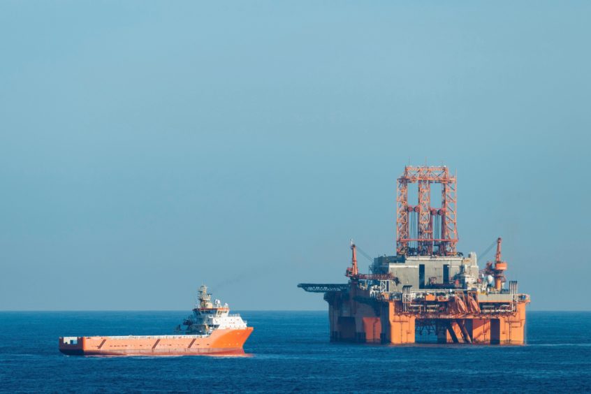 Supply vessel Normand Aurora next to West Phoenix oil rig in the North Sea. Olaf Kruger/imageBROKER/Shutterstock