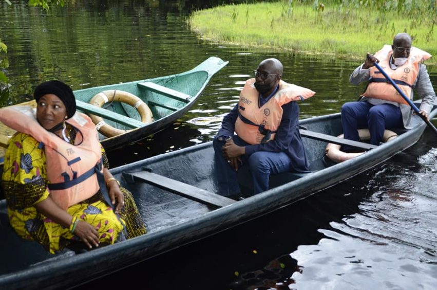 Two men and a woman in a canoe