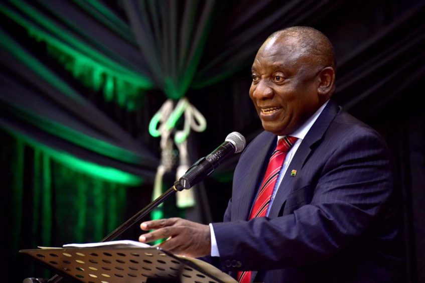 Man at podium in suit gesturing