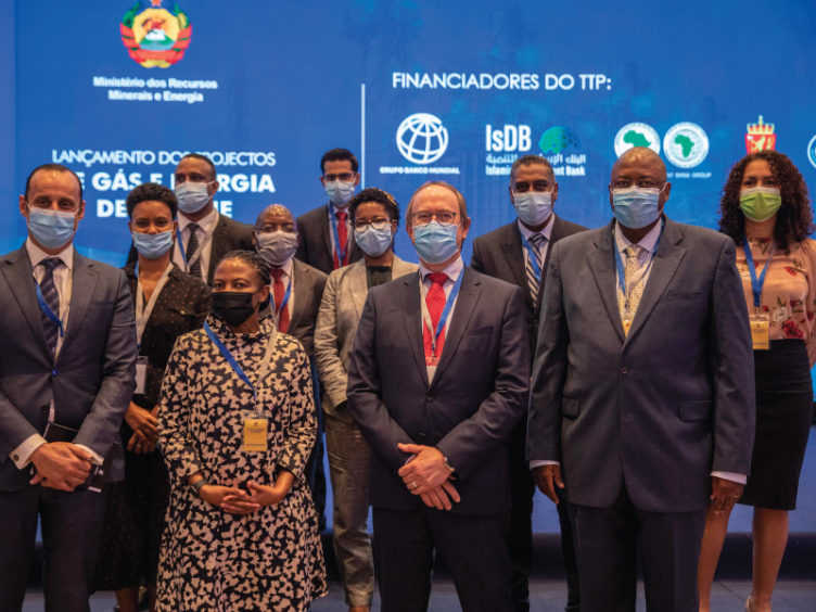 Group of people in suits against a blue background