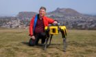 Undated handout photo issued by Heriot-Watt University of Prof Yvan Petillot with a four-legged robot "dog" which is helping scientists in Scotland research how the machines can help people working in hazardous environments such as oil platforms and refineries, on Blackford Hill, Edinburgh. Heriot-Watt University/PA Wire