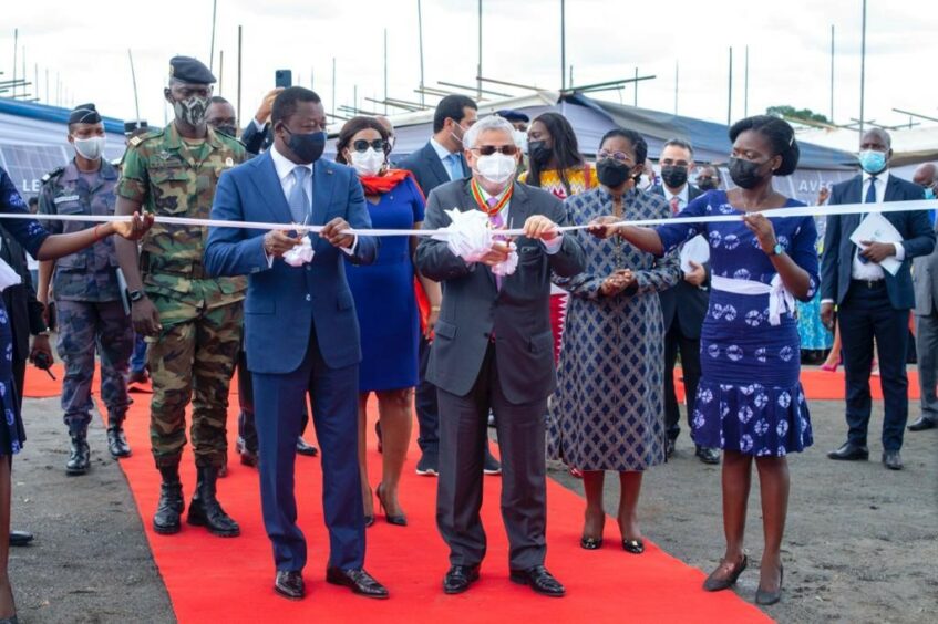 Ribbon cutting on a red carpet