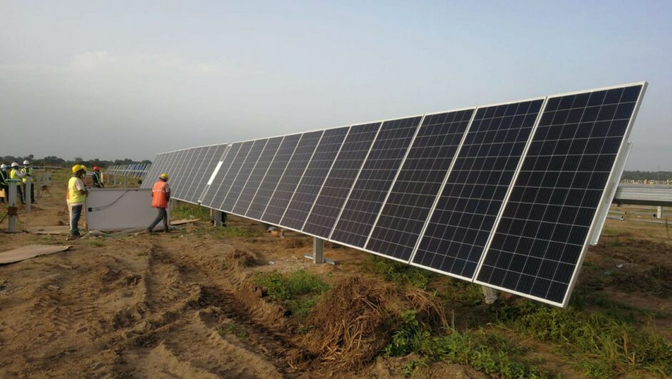 Solar panel with two workers in high-vis equipment