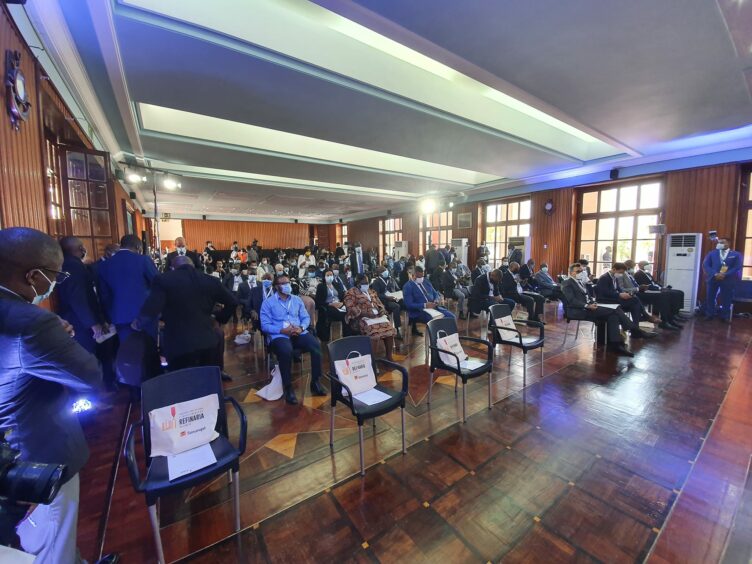 People attend a presentation with a row of empty seats in front