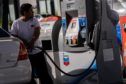 A customer refuels at a Chevron Corp. gas station in San Francisco, California, U.S., on Wednesday, July 7, 2021. The average price of gas nationwide has climbed to $3.13, a high for the year and up 40% since January 1, CBS News reports.
