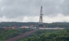 A drilling rig in a cloudy landscape