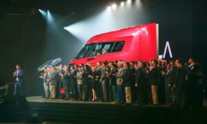 Truck on a stage with clapping people in foreground