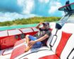 Man reclines in a speedboat under a blue sky