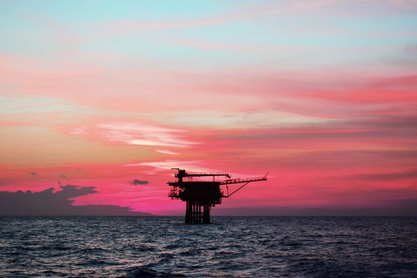 Offshore platform in Southeast Asia at sunset.