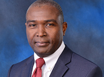 Headshot of man with red tie 