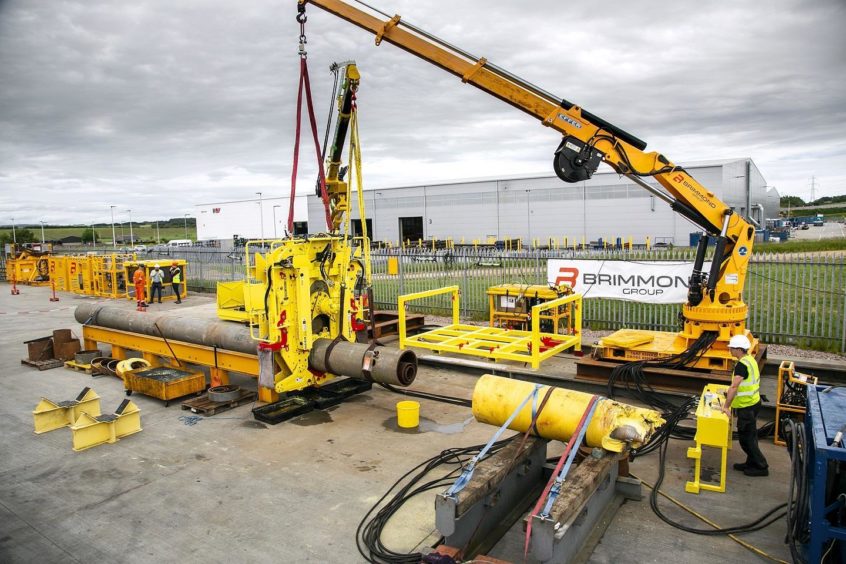 Decom Engineering's 24 inch Chopsaw securely clamped onto a 24' conductor operated by site technician Emmett Donaghy from a safe distance using a Decom Engineering control panel